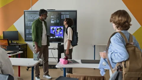Middle Aged Indian Teacher Explaining Coding to Teenager in Classroom Stock Footage 342812963