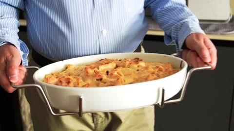 A middle-aged Italian man serving his own homemade pasta to the table Stock Footage 313451837