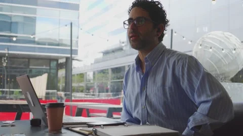 Middle-aged Latin man having an interview with someone out of shot in a cof.. Stock Footage 236329071