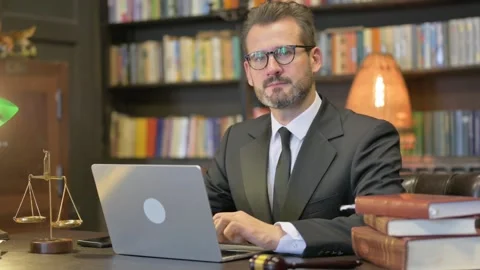 Middle Aged Lawyer Looking at Camera with Laptop Video stock 294294183
