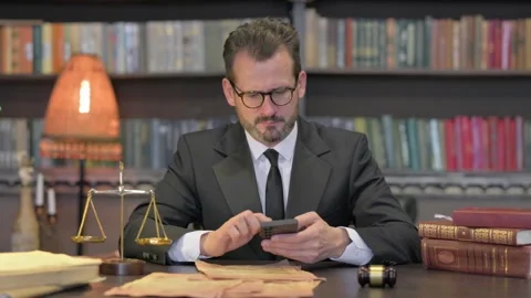 Middle Aged Lawyer Using Smartphone in Office Stock-Footage 294307645