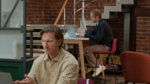 Middle-Aged Male Programmers Sharing Modern Coworking Space Video stock 319994847
