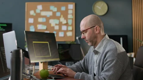 Middle-Aged Male Software Developer Coding at Office Workplace Stock Footage 306835181