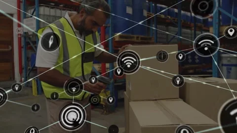 A middle aged male warehouse worker is scanning a label on a box with a barcode Stock Footage 326875758