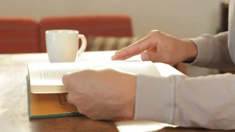 Middle aged male's hand turns pages of a book. No face. 25P. Stock Footage 224901081