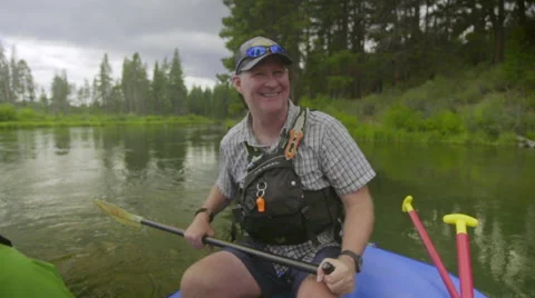 Middle-aged man acts as white water river guide, in portrait Stock Footage 59737106