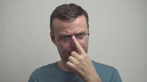 Middle-aged man is adjusting glasses. Portrait of sullen person Stock Footage 318525520