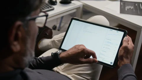 Middle Aged Man Analyzing Cybersecurity Data on Digital Tablet Stock Footage 347288969