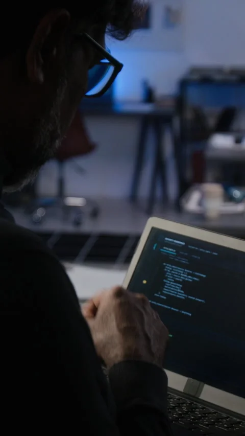 Middle Aged Man Analyzing Cybersecurity Data on Laptop in Office Stock Footage 347312626