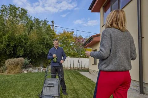 A middle-aged man and his wife work in the garden and do various maintenanc.. Stock Photos