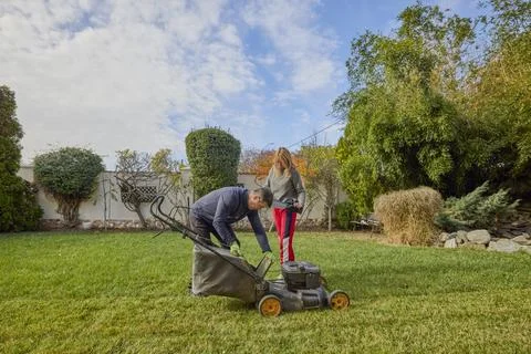 A middle-aged man and his wife work in the garden and do various maintenanc.. Stock Photos