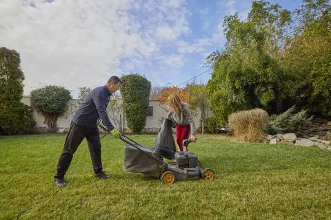 A middle-aged man and his wife work in the garden and do various maintenanc.. Stock Photos