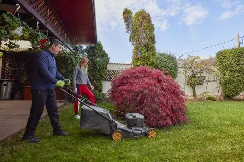 A middle-aged man and his wife work in the garden and do various maintenanc.. Stock Photos
