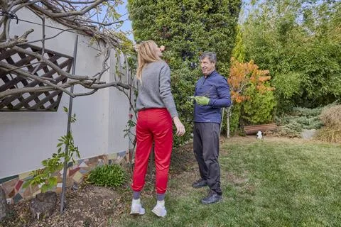 A middle-aged man and his wife work in the garden and do various maintenanc.. Stock Photos