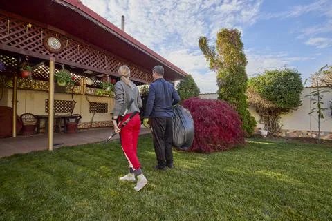 A middle-aged man and his wife work in the garden and do various maintenanc.. Stock Photos