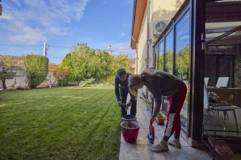 A middle-aged man and his wife work in the garden and do various maintenanc.. Stock Photos