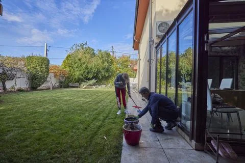 A middle-aged man and his wife work in the garden and do various maintenanc.. Stock Photos