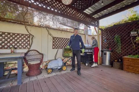 A middle-aged man and his wife work in the garden and do various maintenanc.. Stock Photos