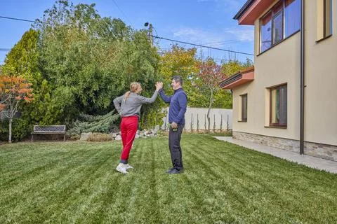 A middle-aged man and his wife work in the garden and do various maintenanc.. Stock Photos