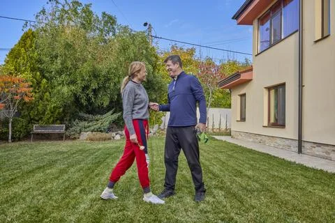 A middle-aged man and his wife work in the garden and do various maintenanc.. Stock Photos