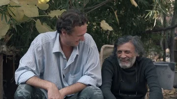 Middle-aged man and white-haired old man sitting outdoors and laughing. Close-up Stock Footage 85670901