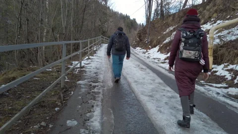Middle aged man and young woman backpacker traveling at the mountain terrain.  Видео 148448704