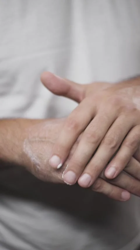 Middle aged man applying healing cream on dry hands vertical reel closeup Stock Footage 342240264