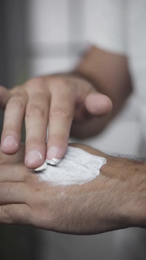 Middle aged man applying healing moisturising cream on hands vertical reel Stock Footage 342240272