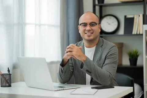 A middle-aged man around the age of 35. Working at home Work through the lapt Stock Photos