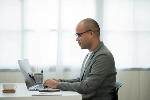 A middle-aged man around the age of 35. Working at home Work through the lapt Stock Photos