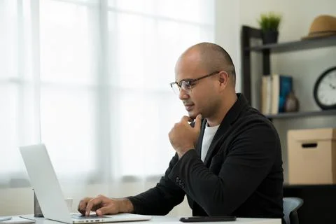 A middle-aged man around the age of 35. Working at home Work through the lapt Stock Photos
