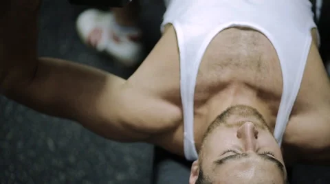 Middle-aged man athlete completes the exercise on biceps muscles of hands, lying Stock Footage 57253692
