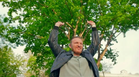 Middle-aged man on a background of spring tree enjoying life Stock Footage 49966271