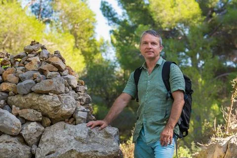 Middle aged man with backpack explores picturesque landscapes Majorca - mount Stock Photos