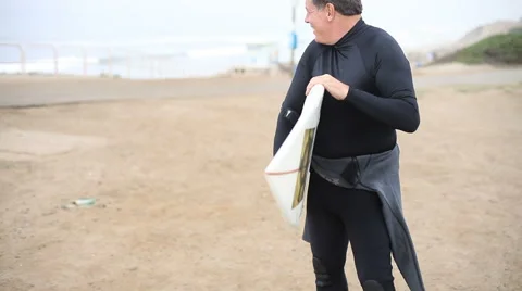 Middle aged man at beach with surf board Stock-Footage 62279353