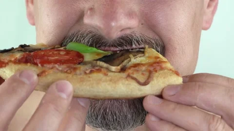 Middle aged man with beard holding in hands eating vegetarian pizza, 4K close up Stock Footage 157114695