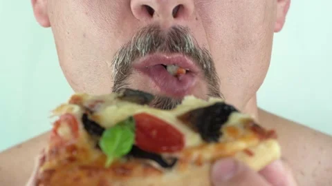 Middle aged man with beard holding in hands eating vegetarian pizza, 4K close up Stock Footage 157788661