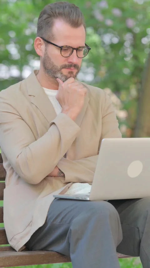 Middle Aged Man Brainstorming Middle Aged Man Reading on Laptop while Sitting 스톡 동영상 319012918