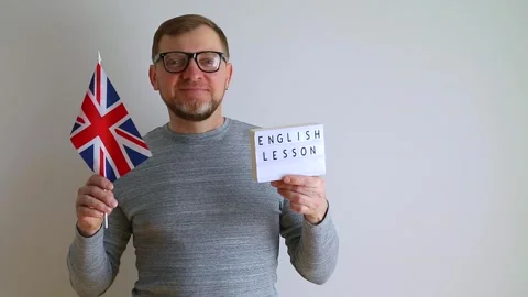 Middle aged man with a British flag in glasses. English Lesson. Stock Footage 240108383