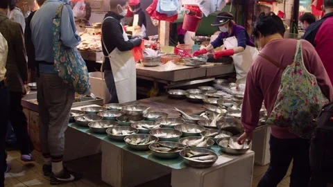 Middle aged man buying fish from wet market Stock Footage 249884505