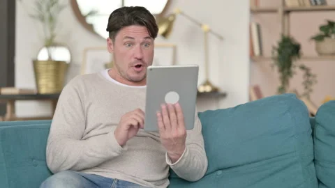 Middle Aged Man Celebrating on Tablet, at Home 스톡 동영상 142373518