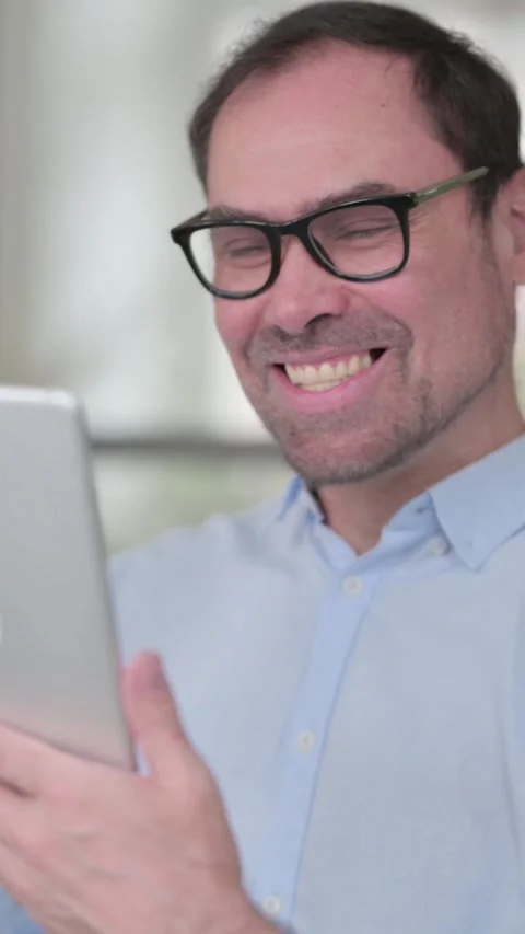 Middle Aged Man Celebrating on Tablet in Office, Vertical Video 스톡 동영상 339584239