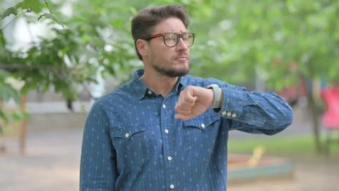 Middle Aged Man Checking Time on Smartwatch Outdoors Видео 311380521