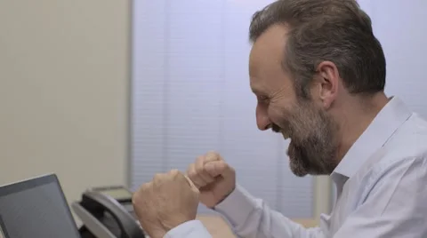Middle aged man checks online account and celebrates Video stock 68614733