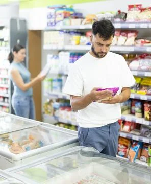 Middle-aged man choosing dried corn kernels in supermarket Stock Photos