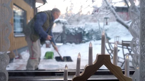 A middle-aged man is cleaning snow in the backyard Stock Footage 297868824