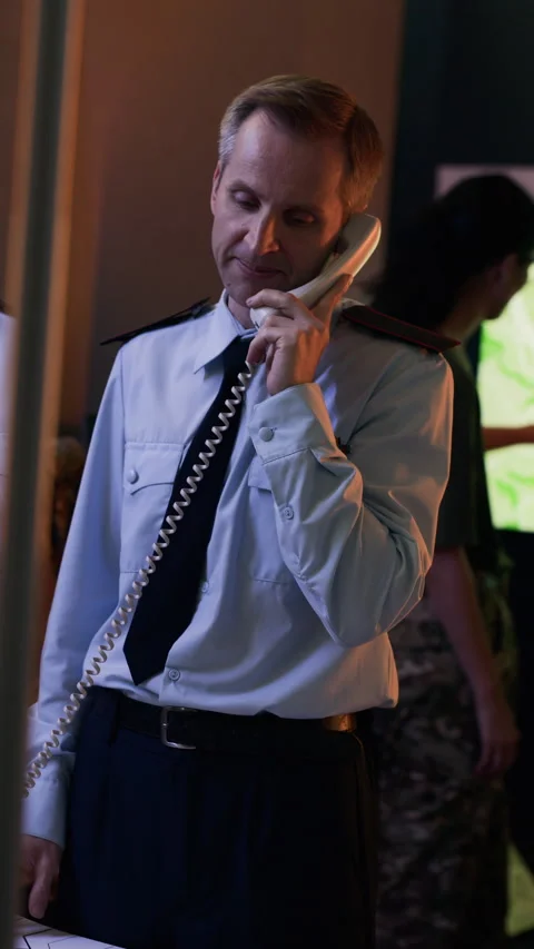 Middle-aged Man in Command Center Speaking on Telephone Stock Footage 343737671