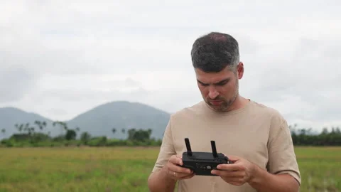 Middle aged man controls advanced tech gadgets. Drone remote control panel Video stock 323054674