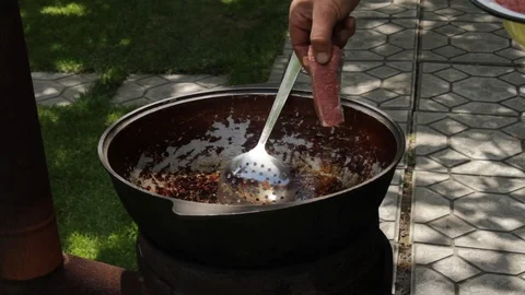 A middle-aged man cooks meat in the garden at his home Video stock 109505397