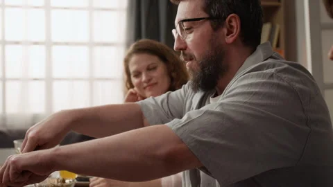 Middle Aged Man Cutting Roasted Meat for Family Dinner Stock Footage 340335558